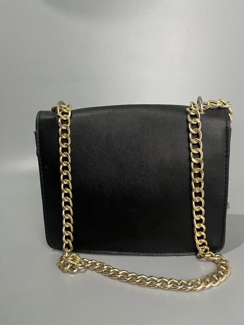 Gucci GG Marmont Shoulder Bag (Category: Luxury Bags & Wallets) located in Lucena. Submitted by brkrobert (Listing ID 1452666918, Image 3). Description: - Gucci shoulder bag in black and beige. - Features iconic gold-toned GG logo hardware. - Elegant gold chain strap. - Plain black leather back. - Ideal for evening wear or making a fashion statement. - minor scratches and signs of wear.