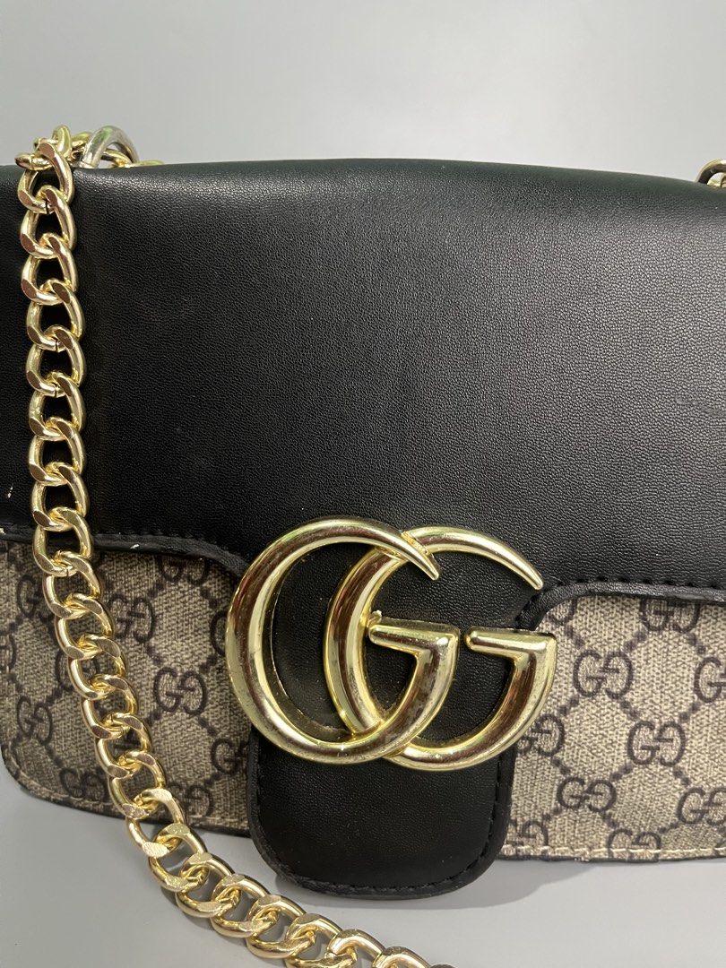 Gucci GG Marmont Shoulder Bag (Category: Luxury Bags & Wallets) located in Lucena. Submitted by brkrobert (Listing ID 1452666918, Image 2). Description: - Gucci shoulder bag in black and beige. - Features iconic gold-toned GG logo hardware. - Elegant gold chain strap. - Plain black leather back. - Ideal for evening wear or making a fashion statement. - minor scratches and signs of wear.