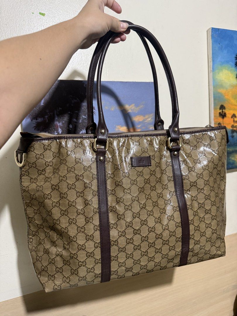 Gucci GG Monogram Coated Canvas Tote Bag (Category: Luxury Bags & Wallets) located in Quezon City. Submitted by vianca13 (Listing ID 1452534222, Image 1). Description: - Classic GG monogram pattern (beige/brown) - Coated canvas with leather trim - Zip top closure - Interior zip pocket - Interior snap button pocket - Serial number: M109993 197750 - Ideal for everyday use or travel.
