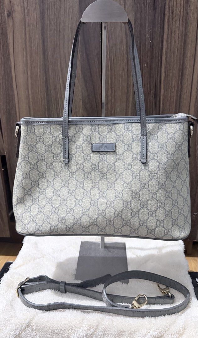 Gucci GG Supreme Small Joy Tote Bag (Category: Luxury Bags & Wallets) located in Manila. Submitted by prelovedbygayle (Listing ID 1452669613, Image 1). Description: GG Supreme Canvas: Crafted from iconic coated microfiber canvas featuring the repeated interlocking GG monogram in a sleek beige and grey color palette. Grey Leather Trim: Outfitted with refined grey leather top handles, matching upper rim piping, and a small centered leather logo pla