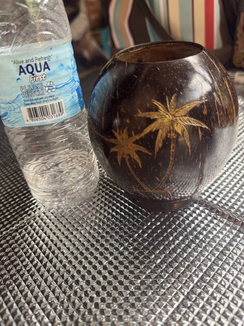 Hand-carved Coconut Shell Cup with Palm Tree Design (Category: Dinnerware & Cutlery) located in Santa Cruz. Submitted by maqui15 (Listing ID 1452509451, Image 1). Description: - Unique cup crafted from a real coconut shell. - Features a hand-carved palm tree design. - Smooth, polished finish for a premium feel. - Versatile: Use for drinks or as a decorative piece. - Size: Approximately 4 inches tall. - Adds a perfect tropical vibe to any setting.