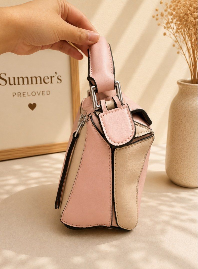Loewe Puzzle Bag (Category: Luxury Bags & Wallets) located in Taguig. Submitted by summers.preloved (Listing ID 1452691179, Image 3). Description: - Loewe Puzzle Bag - Mini Size - Chic Colorblock Design (Pink & Beige) - Top Handle - Secure Zip Closure - Detachable Strap for Versatile Carrying - Ideal for Everyday Use.