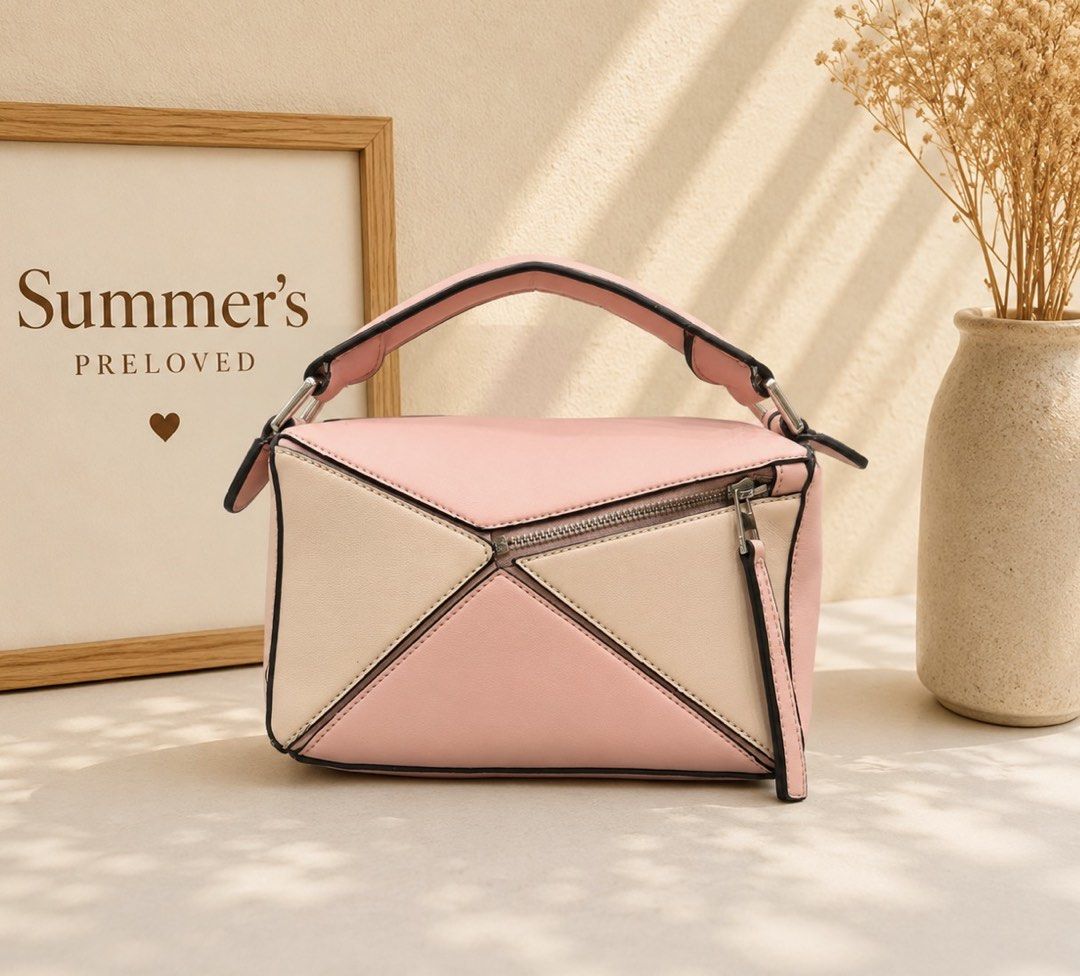 Loewe Puzzle Bag (Category: Luxury Bags & Wallets) located in Taguig. Submitted by summers.preloved (Listing ID 1452691179, Image 2). Description: - Loewe Puzzle Bag - Mini Size - Chic Colorblock Design (Pink & Beige) - Top Handle - Secure Zip Closure - Detachable Strap for Versatile Carrying - Ideal for Everyday Use.