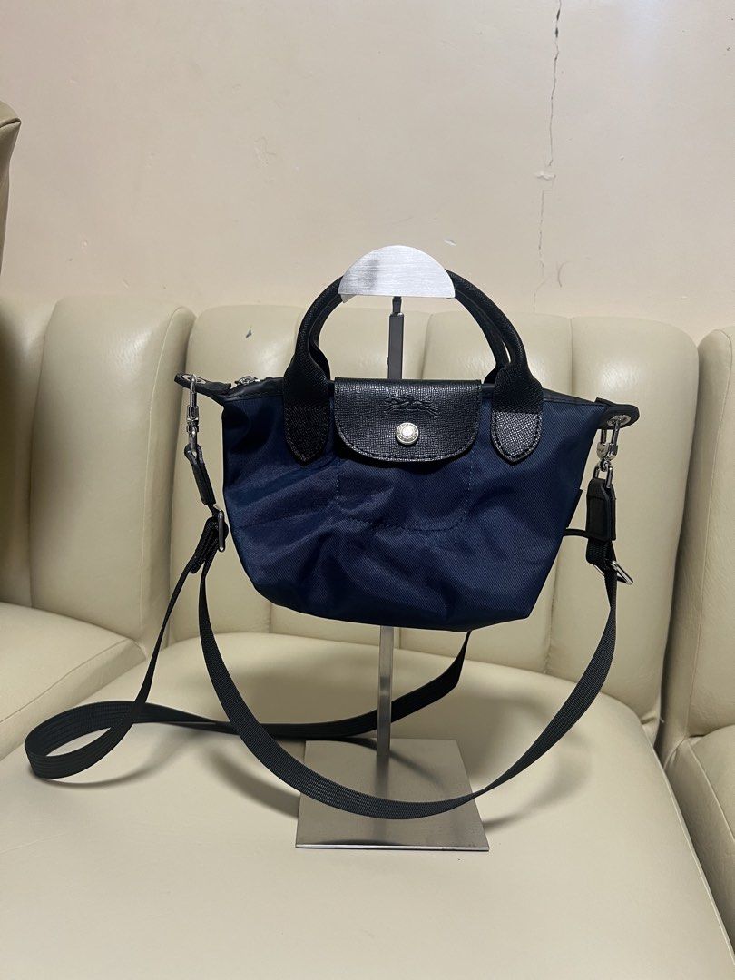 Longchamp Le Pliage Energy Mini Navy (Category: Luxury Bags & Wallets) located in Manila. Submitted by gailmg (Listing ID 1452587891, Image 1). Description: - Authentic! - Navy blue Longchamp mini bag - Top handles and detachable shoulder strap - Black leather trim - Flap closure with snap button - Top zippers - Small size, ideal for essentials - Great for casual outings or light travel.