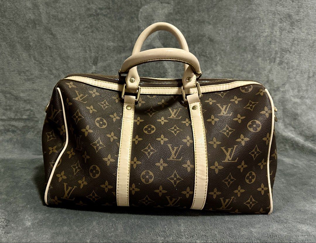 Louis Vuitton Keepall Bandouliere Bag Monogram 40 (Category: Luxury Bags & Wallets) located in Candaba. Submitted by shokgold19 (Listing ID 1452587712, Image 1). Description: - Classic Louis Vuitton Keepall Bandouliere 40 - Monogram canvas with beige leather trim - Gold-tone hardware - Zipper closure - Timeless and versatile for daily use or travel - Shows some signs of wear on leather and hardware.