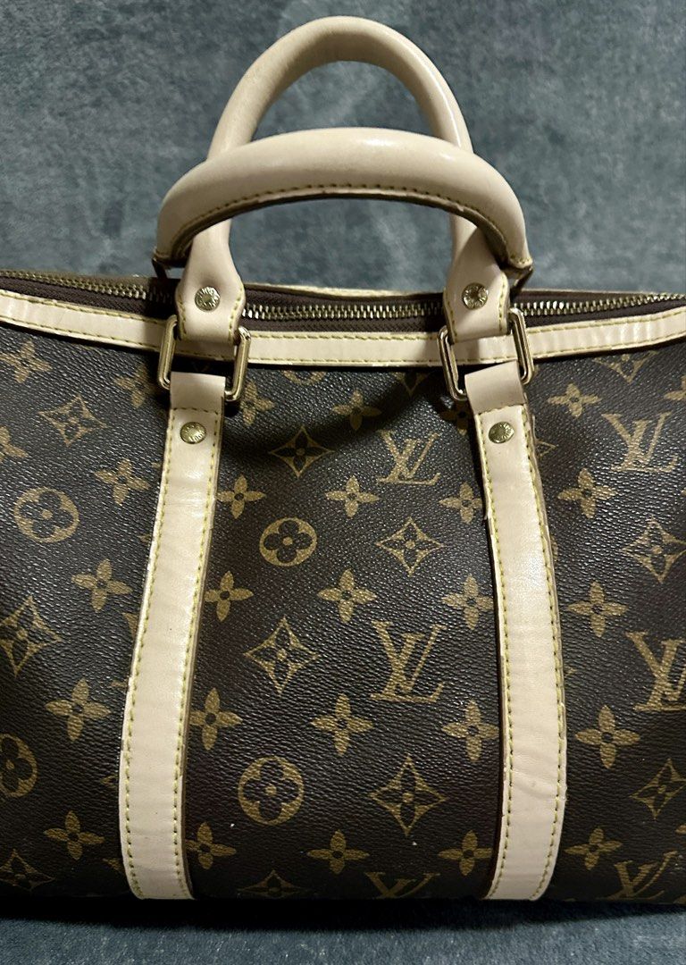 Louis Vuitton Keepall Bandouliere Bag Monogram 40 (Category: Luxury Bags & Wallets) located in Candaba. Submitted by shokgold19 (Listing ID 1452587712, Image 2). Description: - Classic Louis Vuitton Keepall Bandouliere 40 - Monogram canvas with beige leather trim - Gold-tone hardware - Zipper closure - Timeless and versatile for daily use or travel - Shows some signs of wear on leather and hardware.
