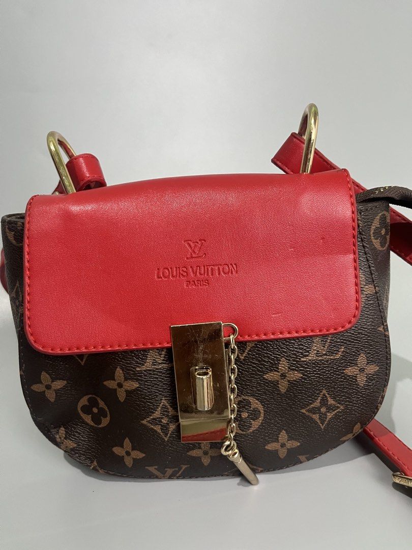 Louis Vuitton Monogram Red Leather Saddle Bag (Category: Luxury Bags & Wallets) located in Lucena. Submitted by brkrobert (Listing ID 1452666690, Image 2). Description: - Louis Vuitton saddle bag - no tags - Iconic monogram canvas - Vibrant red leather flap and strap - Gold hardware details - Interior zippered pocket and compartments - Versatile for everyday or evening wear - Adds a pop of color to any outfit.