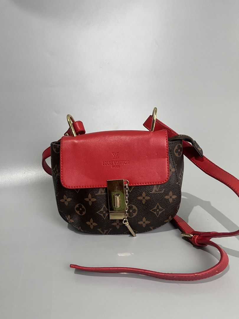 Louis Vuitton Monogram Red Leather Saddle Bag (Category: Luxury Bags & Wallets) located in Lucena. Submitted by brkrobert (Listing ID 1452666690, Image 1). Description: - Louis Vuitton saddle bag - no tags - Iconic monogram canvas - Vibrant red leather flap and strap - Gold hardware details - Interior zippered pocket and compartments - Versatile for everyday or evening wear - Adds a pop of color to any outfit.