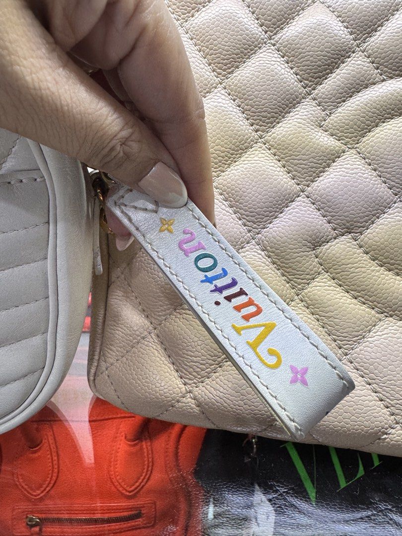 Louis Vuitton White Quilted Camera Bag (Category: Luxury Bags & Wallets) located in Quezon City. Submitted by derill_shop (Listing ID 1452693923, Image 3). Description: - Authentic Louis Vuitton camera bag in elegant white. - Features a stylish quilted design. - Accented with luxurious gold hardware. - Comes with a convenient detachable strap. - Adorned with a small leather tag showcasing colorful Louis Vuitton logo details. - Versatile for every