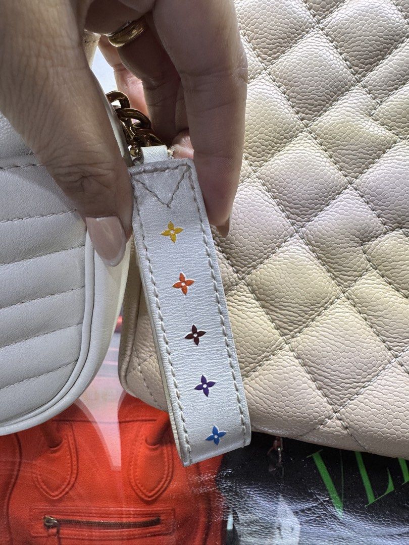 Louis Vuitton White Quilted Camera Bag (Category: Luxury Bags & Wallets) located in Quezon City. Submitted by derill_shop (Listing ID 1452693923, Image 2). Description: - Authentic Louis Vuitton camera bag in elegant white. - Features a stylish quilted design. - Accented with luxurious gold hardware. - Comes with a convenient detachable strap. - Adorned with a small leather tag showcasing colorful Louis Vuitton logo details. - Versatile for every