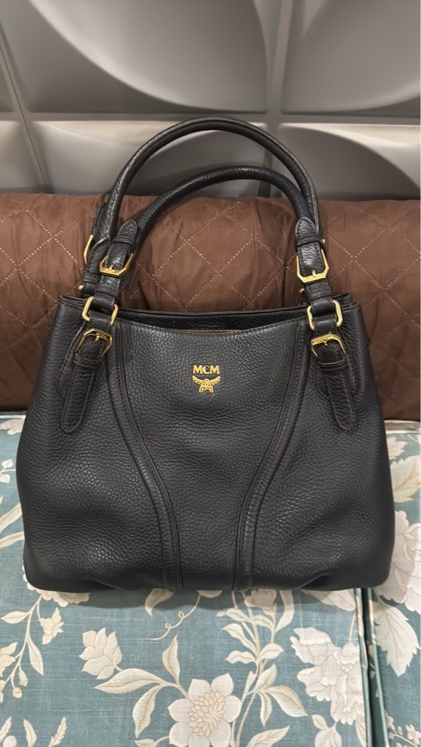 MCM Black Leather Tote Bag (Category: Luxury Bags & Wallets) located in Las Pinas. Submitted by marscollectionsph (Listing ID 1452511472, Image 1). Description: - Genuine black leather MCM tote bag - Elegant gold hardware details - Interior features signature MCM logo lining - Ample space for all your essentials - Ideal for everyday use - PRELOVED.