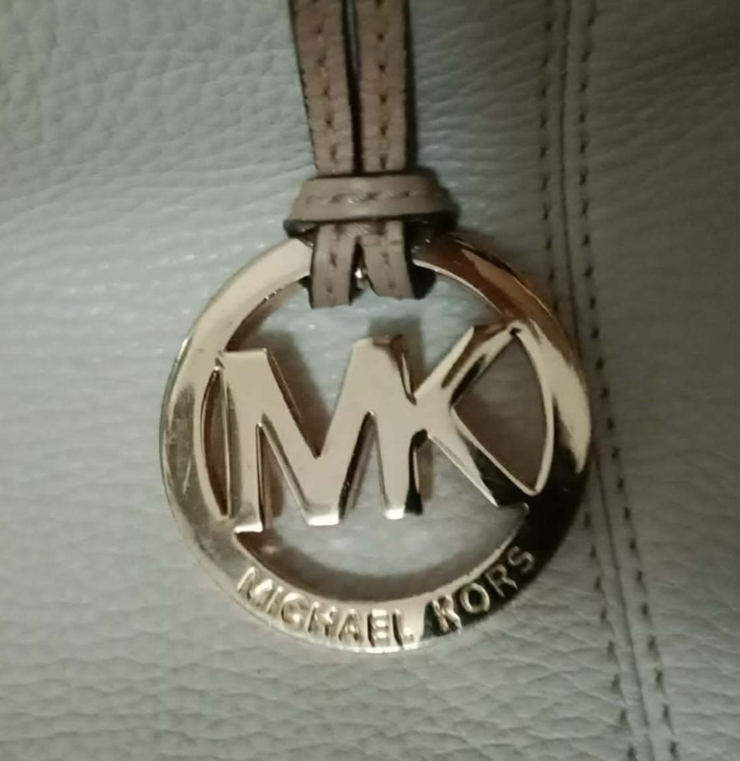 Michael Kors White Leather Tote Bag9 (Category: Luxury Bags & Wallets) located in Calapan. Submitted by jyka12345 (Listing ID 1452601125, Image 2). Description: - Authentic Michael Kors white leather tote bag - Beige leather straps - Gold MK logo charm included - Ample interior space - Ideal for everyday use or travel - Clean and well-maintained interior.