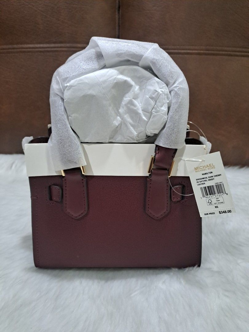 Michael Kors XS Hamilton Sling Bag ORIGINAL (Category: Cross-body Bags) located in Marikina City. Submitted by BrandedStuffz (Listing ID 1452642639, Image 2). Description: Size: H 5.5 x L 7 x W 3.25 inches Adjustable and removable long strap: 18 to 24 inches Color: Dark Cherry Gold-tone hardware. Brand New With tag and care card. Bag sealed/wrapped. 💯% Original/Legit from US 🇺🇸..
