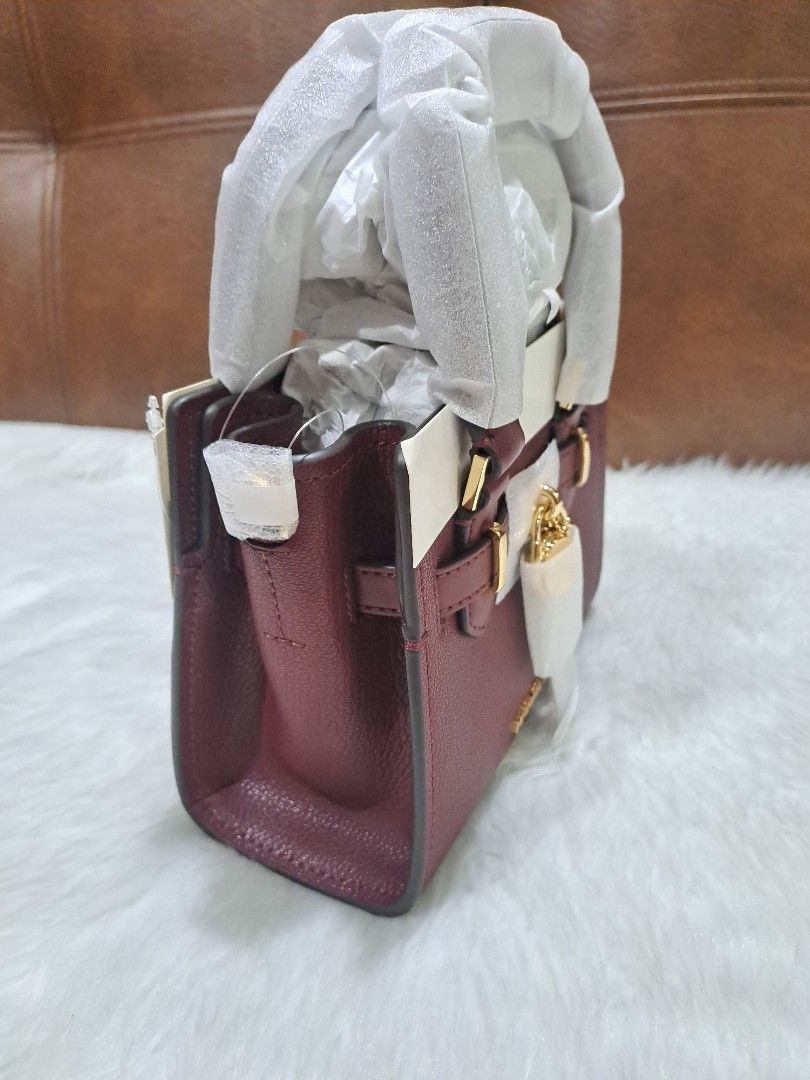 Michael Kors XS Hamilton Sling Bag ORIGINAL (Category: Cross-body Bags) located in Marikina City. Submitted by BrandedStuffz (Listing ID 1452642639, Image 3). Description: Size: H 5.5 x L 7 x W 3.25 inches Adjustable and removable long strap: 18 to 24 inches Color: Dark Cherry Gold-tone hardware. Brand New With tag and care card. Bag sealed/wrapped. 💯% Original/Legit from US 🇺🇸..