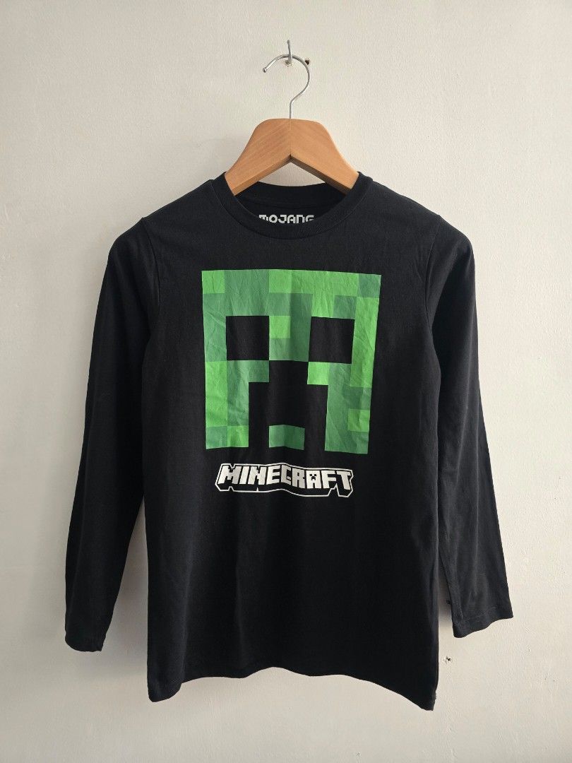 Minecraft Creeper Long Sleeve T-Shirt (Category: Tshirts & Polo Shirts ) located in Quezon City. Submitted by eivan____orong (Listing ID 1452545495, Image 1). Description: - Dimes (25L x 17W) medium fittings - Official Minecraft product by Mad Engine - Black long sleeve t-shirt - Features iconic Creeper design on front - Size: LG/G/G - Material: 60% Cotton, 40% Polyester - Ideal for any Minecraft enthusiast.