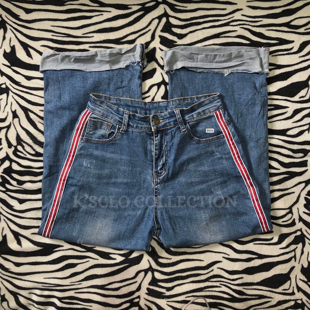 Mom Jeans (Category: Jeans) located in Muntinlupa City. Submitted by ksclocollection (Listing ID 1452674989, Image 1). Description: Blue denim jeans, size medium, with red and white side stripes. Features cuffed hem, distressed front, and button/zip closure. Perfect for casual outfits. 29-30 length 38.