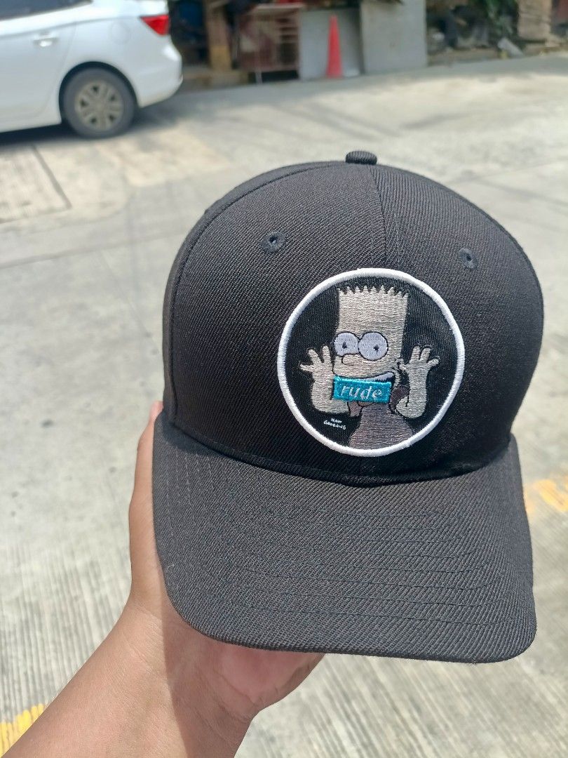 New Era 9FIFTY Bart Simpson "Rude" Snapback Cap (Category: Caps & Hats) located in Manila. Submitted by thriftnival (Listing ID 1452572444, Image 2). Description: - Brand: New Era - Style: 9FIFTY Snapback Cap - Color: Black - Front Graphic: Embroidered Bart Simpson with "Rude" text - Inner Detail: "I'll be good sometimes" text - Size: Medium/Large - Ideal for: Any fan of The Simpsons.