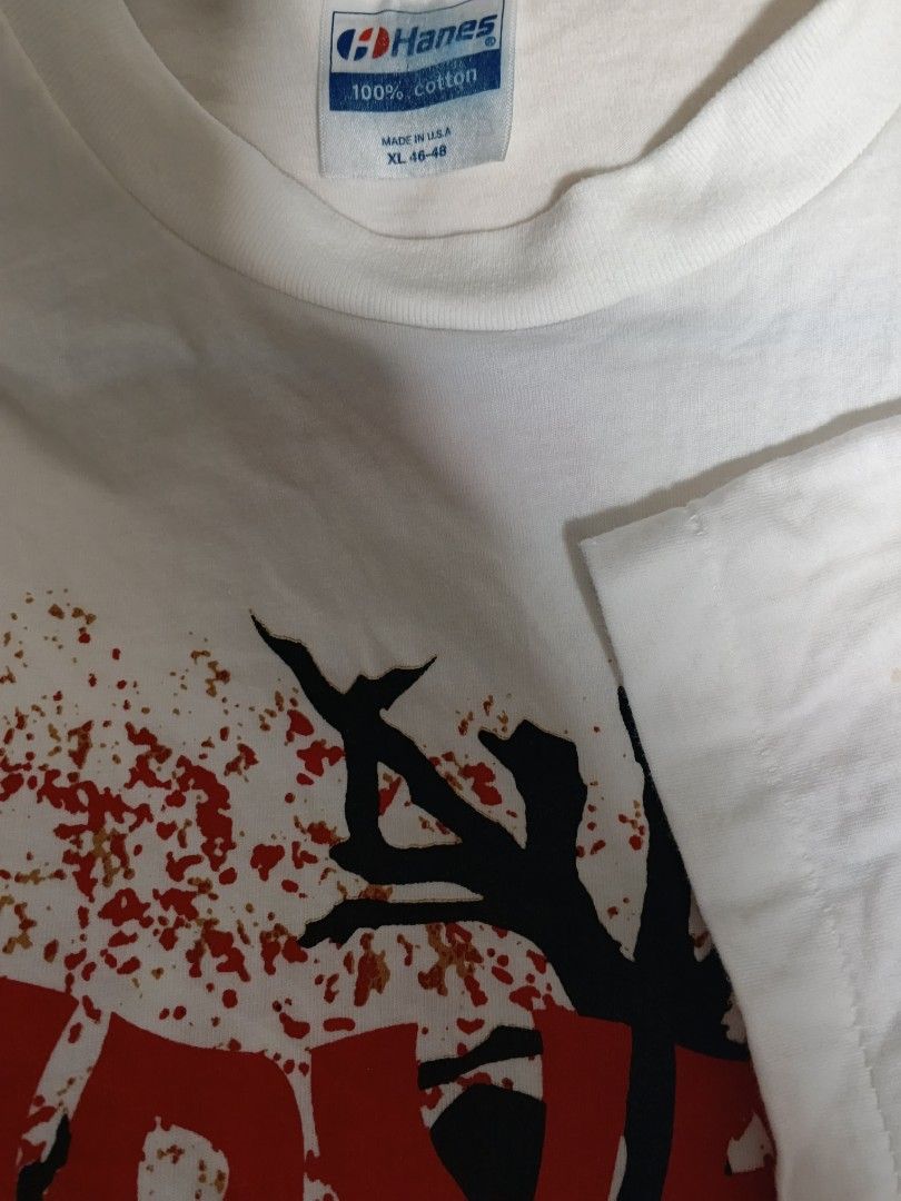 NIRVANA (Category: Tshirts & Polo Shirts) located in Singapore. Submitted by oldskool72 (Listing ID 1452690138, Image 3). Description: - White Hanes t-shirt featuring the band Nirvana. - Size XL (fits 46-48). - 100% cotton, made in USA. - Front graphic: Nirvana band members with logo and distressed tree. - Back graphic: 'Shelter Skelter Merchandising' and 'Nirvana Motherf***ers'. - Classic grunge style..