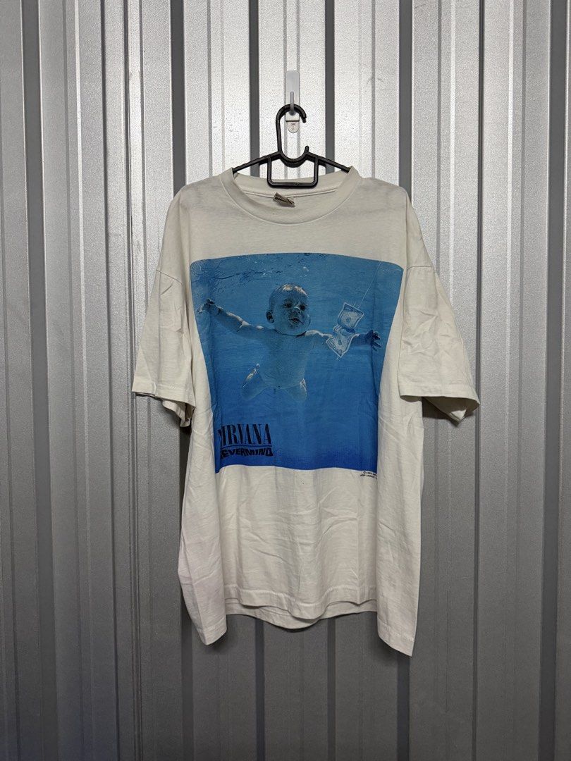 Nirvana (Nevermind) Tee (Category: Tshirts & Polo Shirts) located in Singapore. Submitted by phantogram (Listing ID 1452653794, Image 1). Description: Nirvana Nevermind Album Tee Size XL Length: 69cm Width: 56cm PM for more info! Strictly NO meetups ❌ Mailing Smartpac Only ($5) ✉️✅ tags: tee, shirts,t-shirts, graphic tee,band tees, anime tees,tees, Nirvana.