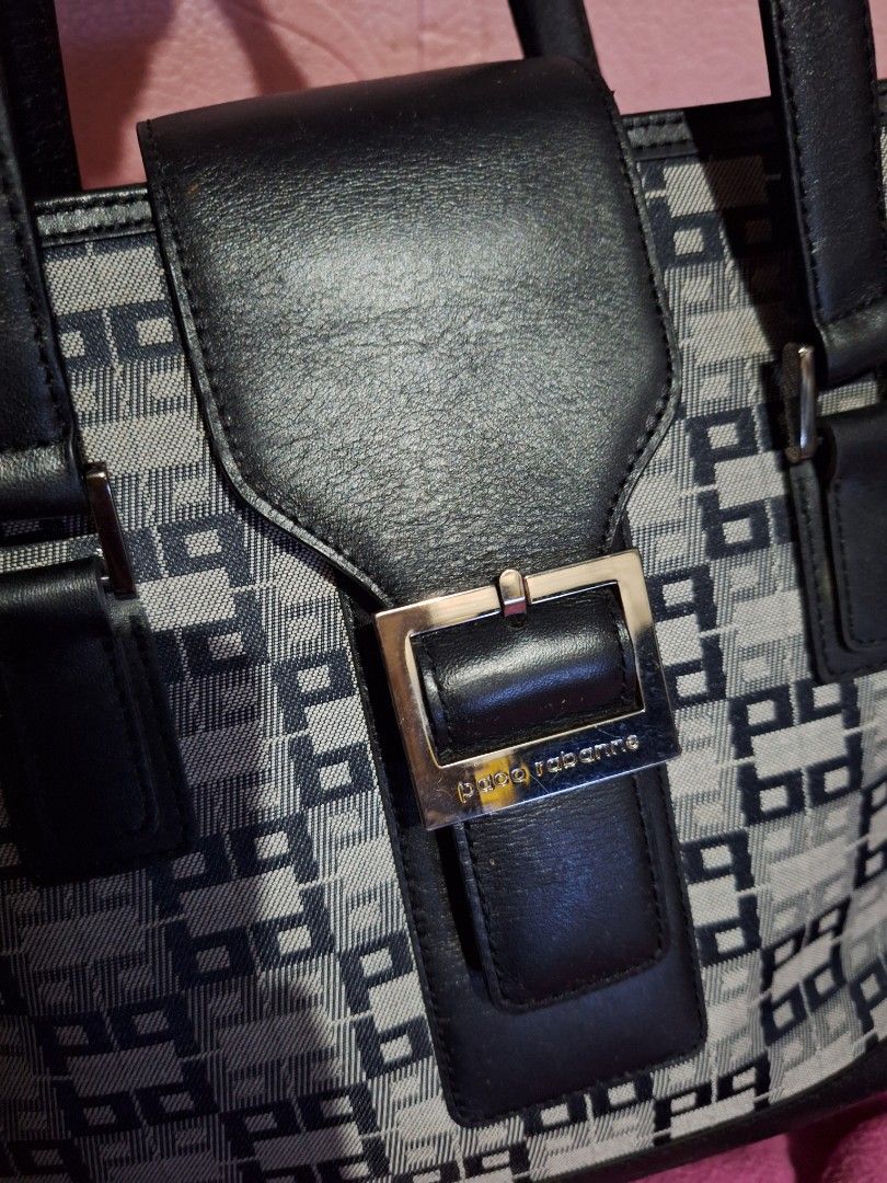 Paco Rabanne Monogram Tote Bag (Category: Luxury Bags & Wallets) located in Quezon City. Submitted by cloudymay (Listing ID 1452416108, Image 2). Description: - Paco Rabanne signature monogram pattern - Black leather trim and handles - Secure zip closure - Metal feet on the bottom - Interior zip pocket - Classic and versatile for everyday use.
