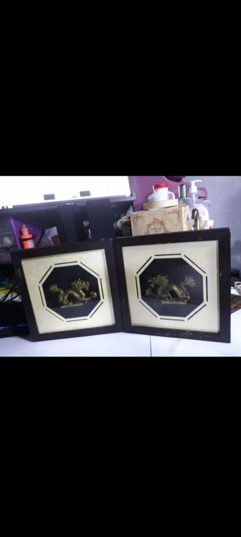 Pair of Framed Dragon Wall Art (Category: Wall Decor) located in Davao. Submitted by bravemoon_556cd5 (Listing ID 1452590150, Image 1). Description: - Set of 2 framed dragon wall art - Features golden dragons on dark background - Dark wood frames - Light cream outer matting - Approx. 25cm x 25cm each - Perfect for adding oriental charm to your space.