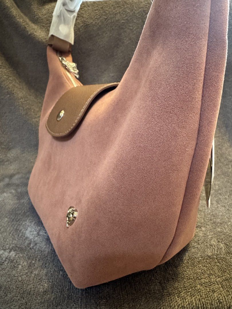 Pony TwentyEight Moya Suede Finish (Category: Shoulder Bags) located in San Miguel. Submitted by meseszy (Listing ID 1452532845, Image 2). Description: Pony TwentyEight Moya Suede 🌟Thailand Pasabuy 🌟Last piece 🌟paubos sale - Adorable pink suede shoulder bag - Stylish brown leather flap with snap closure - Secure silver zipper top closure - Detachable crossbody strap for versatile wear - Protective metal feet on the bottom - Cute small heart lo