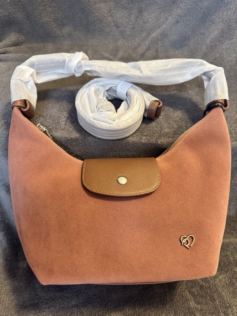 Pony TwentyEight Moya Suede Finish (Category: Shoulder Bags) located in San Miguel. Submitted by meseszy (Listing ID 1452532845, Image 3). Description: Pony TwentyEight Moya Suede 🌟Thailand Pasabuy 🌟Last piece 🌟paubos sale - Adorable pink suede shoulder bag - Stylish brown leather flap with snap closure - Secure silver zipper top closure - Detachable crossbody strap for versatile wear - Protective metal feet on the bottom - Cute small heart lo