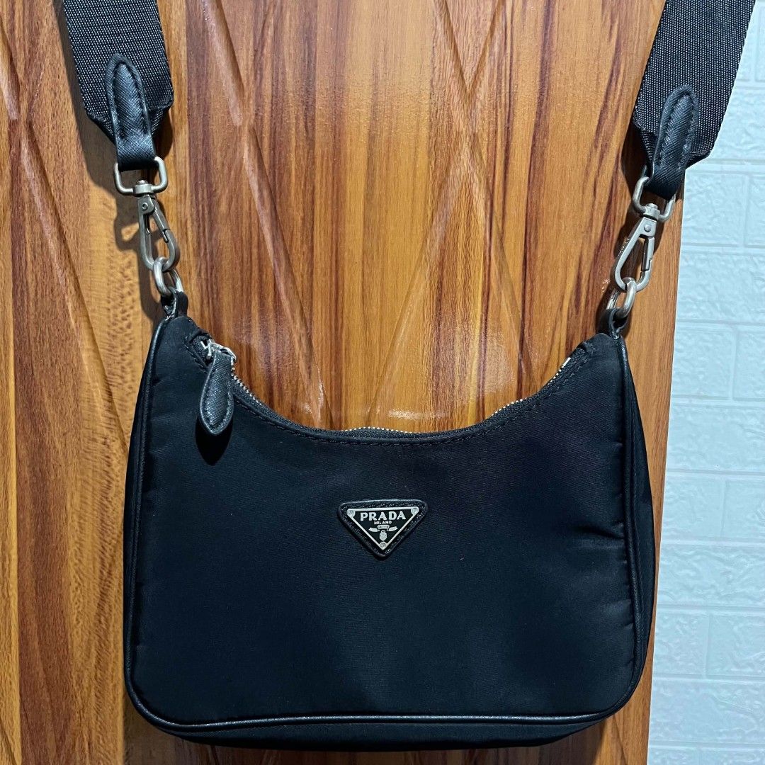 Prada Black Nylon Shoulder Bag (Category: Luxury Bags & Wallets) located in Manila. Submitted by abj_thriftshop (Listing ID 1452533430, Image 2). Description: - Black Prada Shoulder Bag - Durable Nylon Material - Sleek Silver Hardware with Iconic Prada Logo Clasp - Adjustable Shoulder Strap with Prada Branding - Secure Zipper Closure - Ideal for Everyday Use.