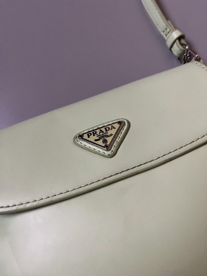 Prada Cleo Flap light green (Category: Luxury Bags & Wallets) located in Lucena. Submitted by brkrobert (Listing ID 1452512651, Image 2). Description: - Prada shoulder bag - Light green leather - Iconic Prada triangle logo - Silver hardware details - Interior slip pocket - Secure snap closure - Ideal for everyday use - minor stains at the back unnoticeable when worn.