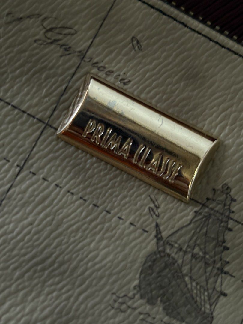 Prima Classe Map Print Clutch Bag (Category: Luxury Bags & Wallets) located in Manila. Submitted by librastudio (Listing ID 1452568438, Image 2). Description: - Authentic Prima Classe bag - Classic map print design - Elegant gold hardware details .