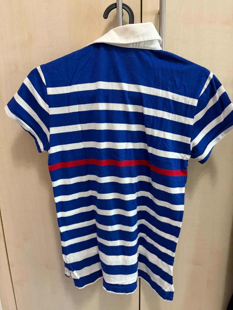 Ralph Lauren Striped Polo Shirt (Category: Babies & Kids Fashion) located in Manila. Submitted by leontheexplorer (Listing ID 1452555449, Image 2). Description: - Brand: Ralph Lauren - Color: Blue and white stripes - Design: Nautical-themed patch on chest, red stripe detail - Size: Medium (M) - Style: Casual wear.