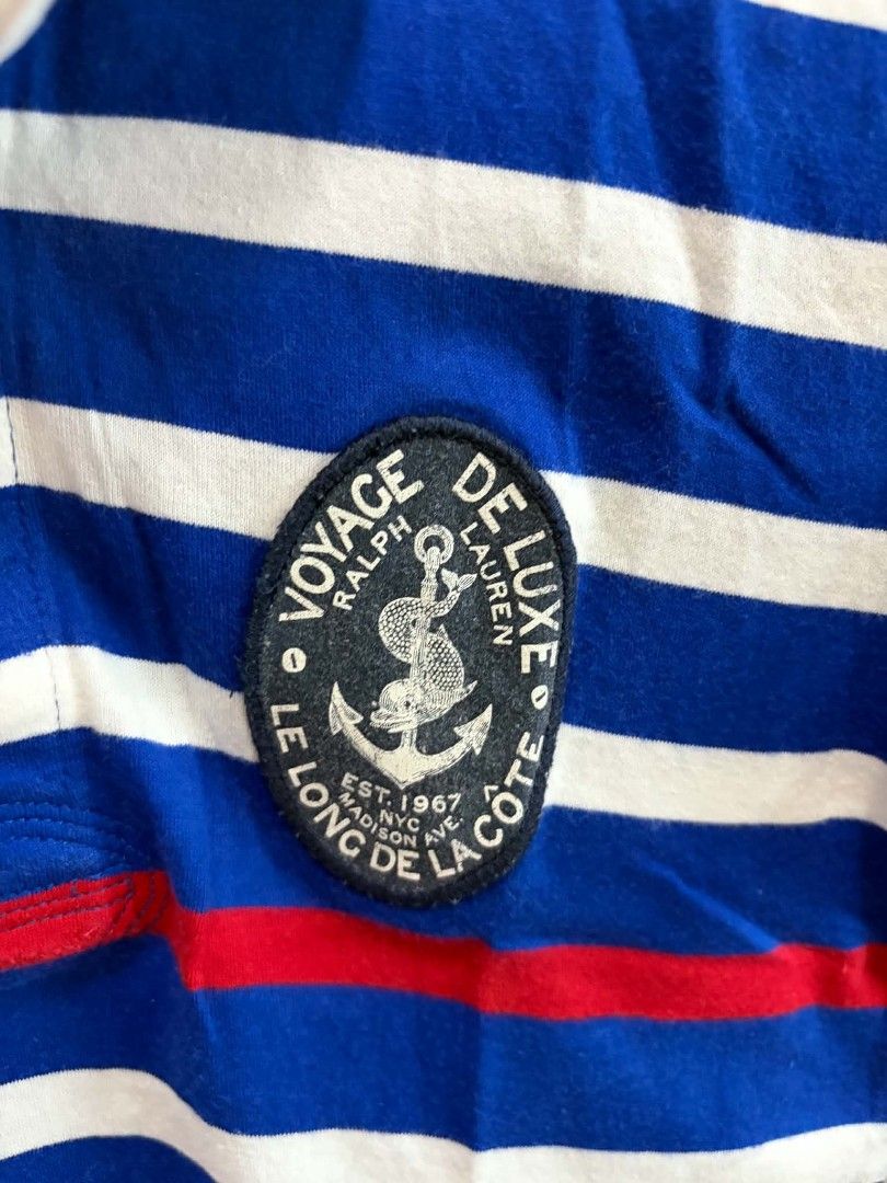Ralph Lauren Striped Polo Shirt (Category: Babies & Kids Fashion) located in Manila. Submitted by leontheexplorer (Listing ID 1452555449, Image 3). Description: - Brand: Ralph Lauren - Color: Blue and white stripes - Design: Nautical-themed patch on chest, red stripe detail - Size: Medium (M) - Style: Casual wear.