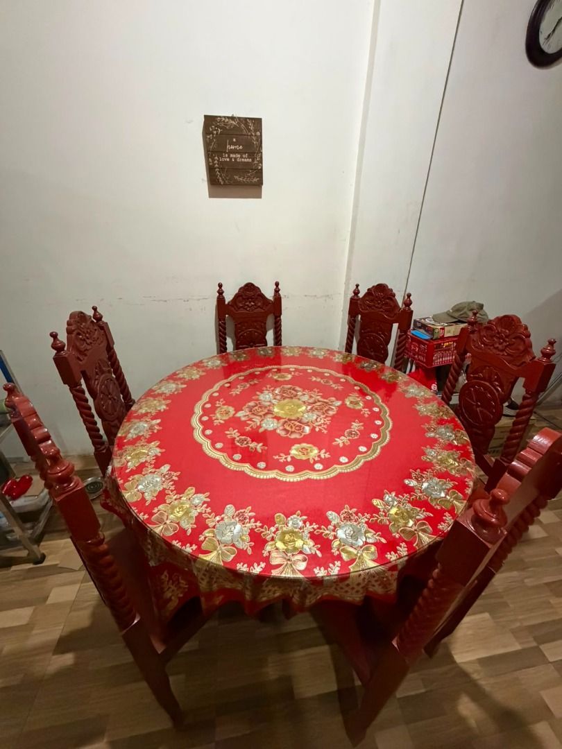 Round Dining Table with 6 Chairs - Red Wood (Category: Tables & Sets) located in Caloocan City. Submitted by chic_and_cheap_finds (Listing ID 1452534580, Image 2). Description: - Solid red wood dining set - Round table with a floral patterned tablecloth - Includes 6 matching chairs with carved details - Ideal for family meals and gatherings - Ready for its new home Sturdy and made with solid wood The stand and wooden table can be disassembled. Di
