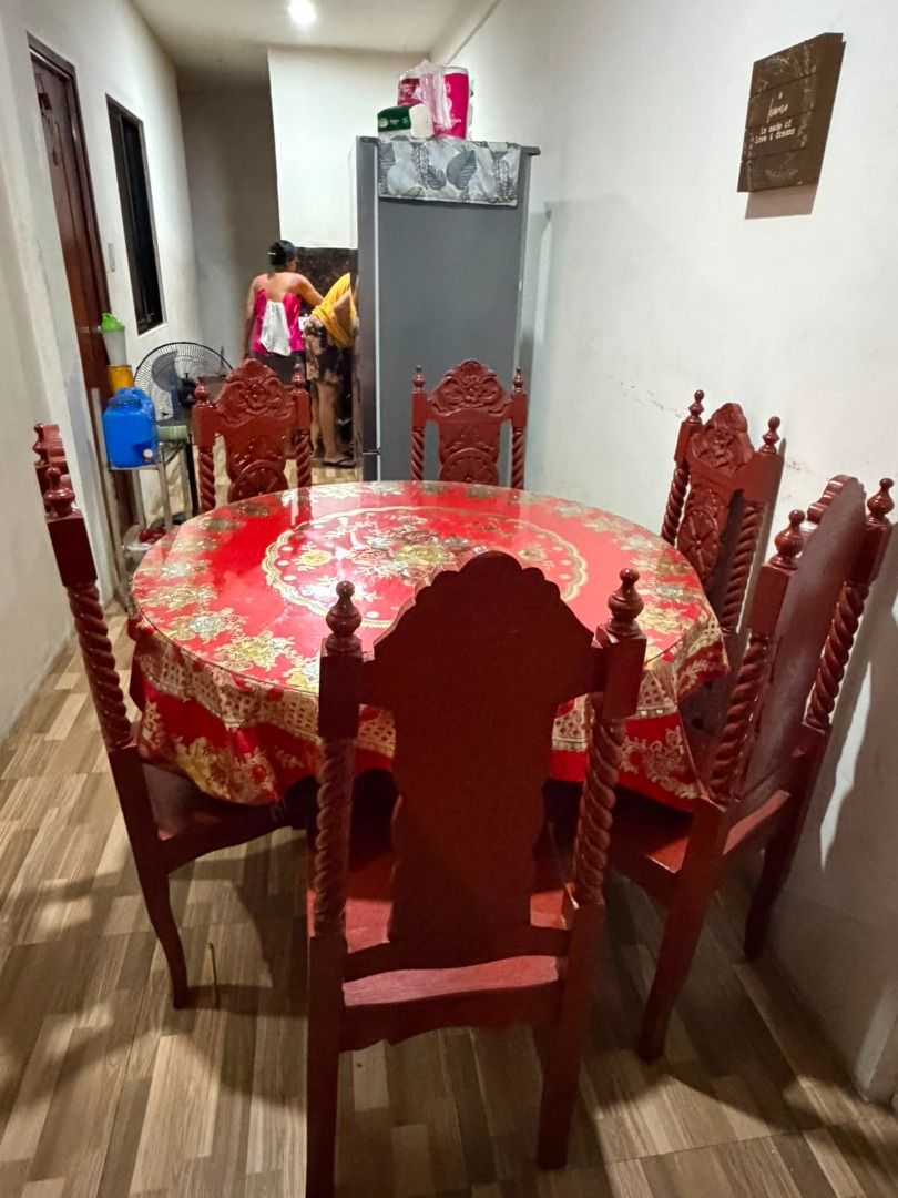 Round Dining Table with 6 Chairs - Red Wood (Category: Tables & Sets) located in Caloocan City. Submitted by chic_and_cheap_finds (Listing ID 1452534580, Image 3). Description: - Solid red wood dining set - Round table with a floral patterned tablecloth - Includes 6 matching chairs with carved details - Ideal for family meals and gatherings - Ready for its new home Sturdy and made with solid wood The stand and wooden table can be disassembled. Di
