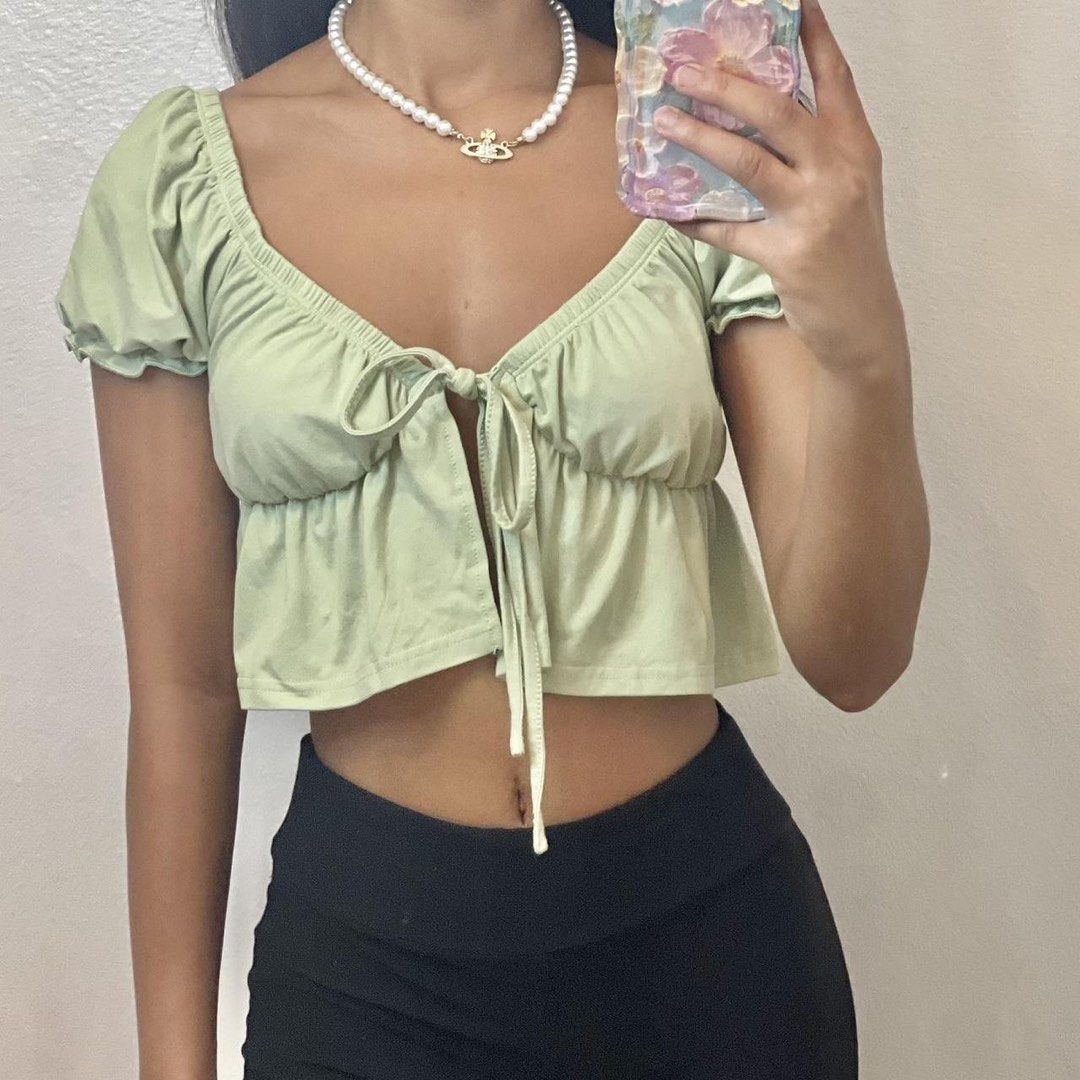 Sage Green Tie Front Crop Top (Category: Others Tops) located in Malabon City. Submitted by k_mby (Listing ID 1452685891, Image 1). Description: Sage green, tie-front crop top from Effordram, featuring short puff sleeves. Still in very good condition. Fits XS-S..