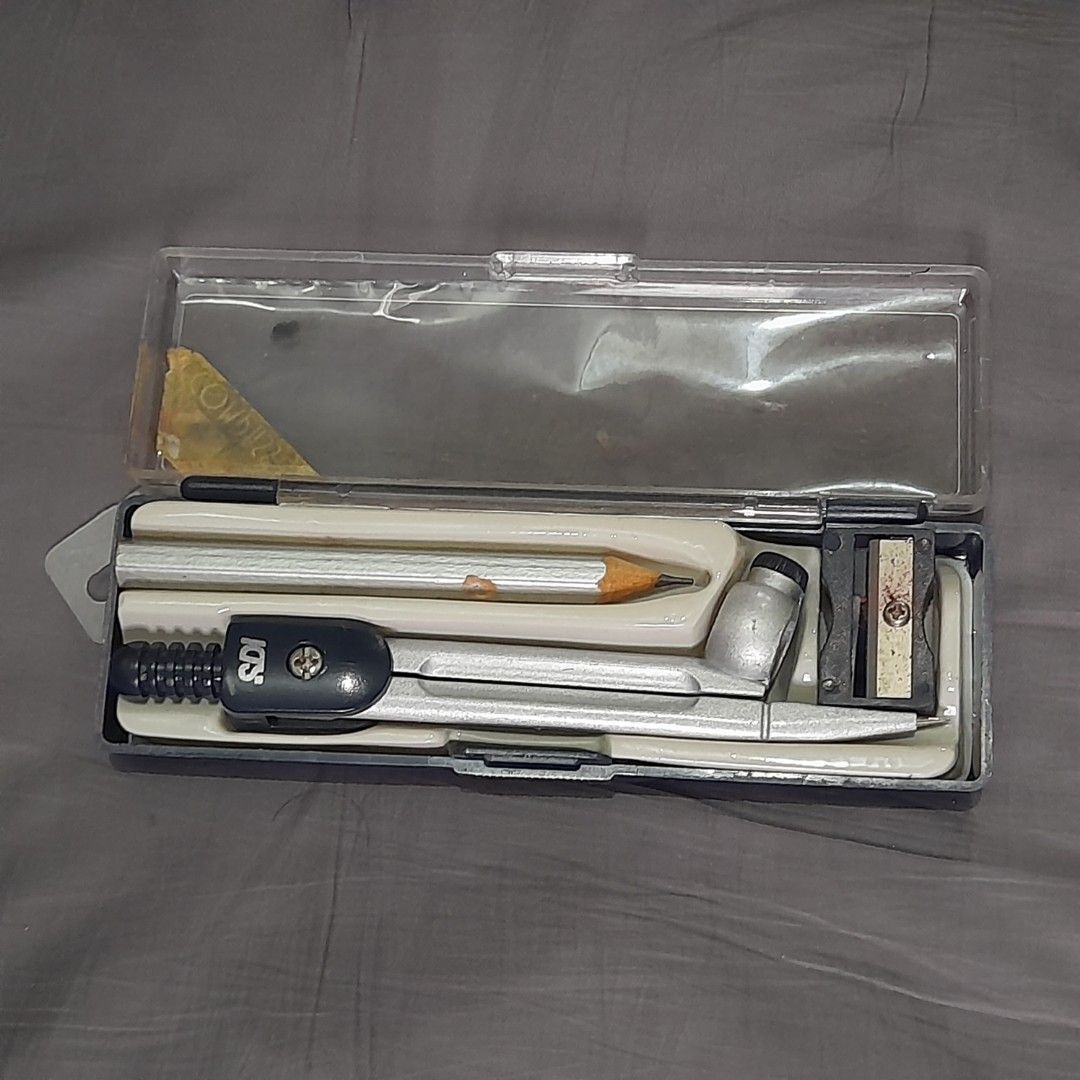 SDI Drawing Compass Set with Pencil & Sharpener (Category: Stationery & School Supplies) located in Dasmarinas. Submitted by pb_declutters (Listing ID 1452531812, Image 1). Description: Selling a pre-loved SDI Drawing Compass Set. Perfect for school geometry classes, drafting, or art projects. What's Included: 1x SDI Metal Drawing Compass 1x Wooden Pencil (sharpened) 1x Small Pencil Sharpener 1x Original Hard Plastic Storage Case Item Condition: 