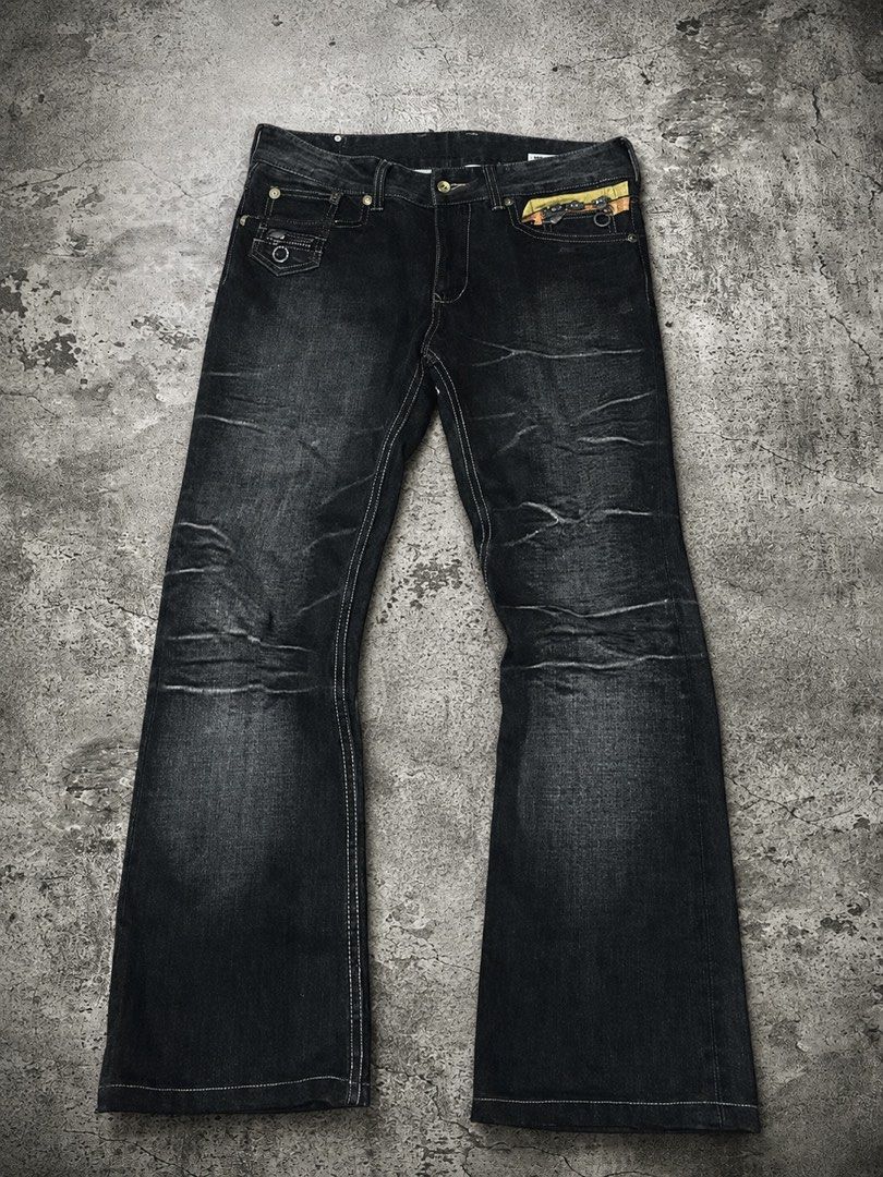 Semantic Design Multi Zip Leather Patch Flared Jeans🇯🇵 (Category: Jeans) located in Caloocan City. Submitted by nagumo.fuku_ (Listing ID 1452560532, Image 1). Description: - Brand: SEMANTIC DESIGN - Color: Black Denim - Fit: Relaxed with a slight flare at the bottom - Pockets: Multiple zip pockets (front and back) - Unique Details: Orange and yellow accents on back pockets - Style: Casual, edgy.