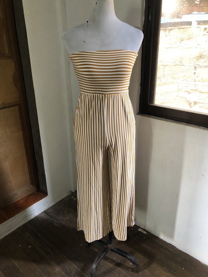 Striped Wide Leg Jumpsuit (Category: Jumpsuits) located in Muntinlupa City. Submitted by ksclocollection (Listing ID 1452574058, Image 3). Description: Chic gold and white striped wide-leg jumpsuit. Features an elasticated waist and strappy top. Made from comfortable, flowy material. Perfect for casual days or beach trips!.