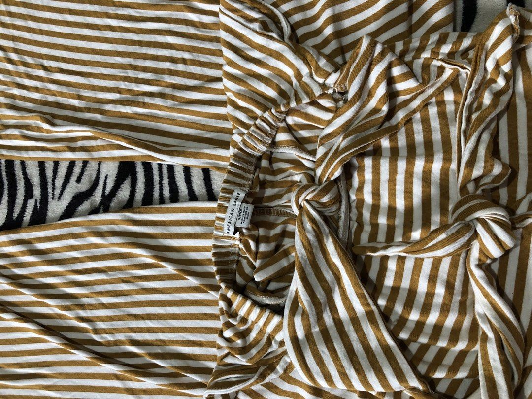 Striped Wide Leg Jumpsuit (Category: Jumpsuits) located in Muntinlupa City. Submitted by ksclocollection (Listing ID 1452574058, Image 2). Description: Chic gold and white striped wide-leg jumpsuit. Features an elasticated waist and strappy top. Made from comfortable, flowy material. Perfect for casual days or beach trips!.