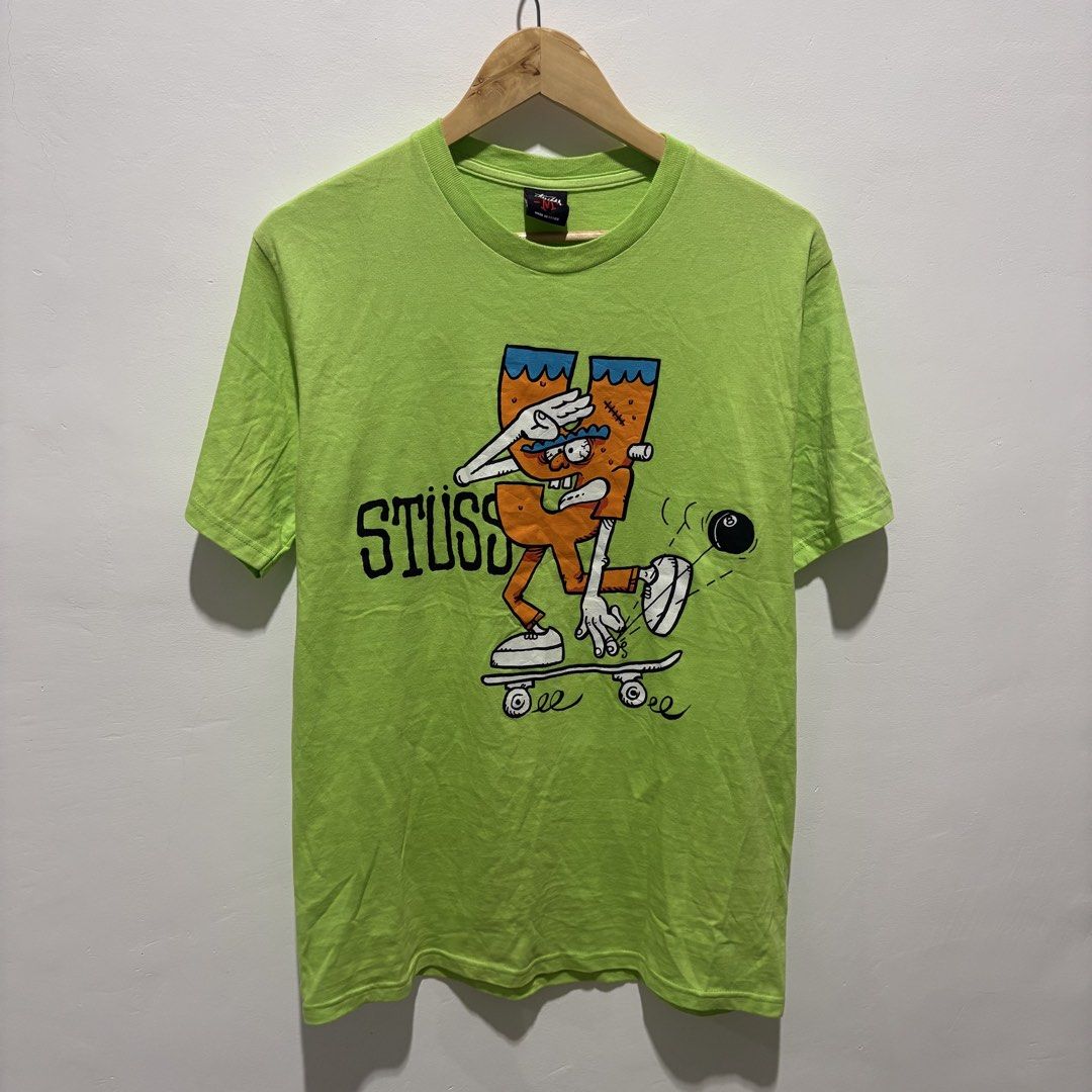 Stussy Graphic Tee Neon Green (Category: Tshirts & Polo Shirts ) located in Dapitan. Submitted by payt3es_thrift. (Listing ID 1452626851, Image 2). Description: - Vibrant neon green Stussy graphic t-shirt. - Features a fun cartoon character skateboarding on the front. - Row of illustrated characters at the back hem. - Made of 100% comfortable cotton. - Easy care: Machine washable. -dimes 19x29.