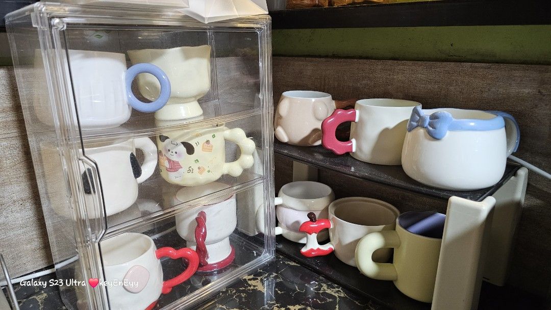 TAKE ALL Cute Ceramic Mugs with Unique Handles (Category: Coffee & Tea Tableware) located in Caloocan City. Submitted by auntieeyy (Listing ID 1452522128, Image 1). Description: TAKE ALL 12 PCS 1200 - Adorable ceramic mugs with unique, playful handle designs. - Features charming animal motifs and cute patterns. - Ideal for coffee, tea, or hot chocolate. - Adds a fun touch to your kitchen or makes a great gift. - Available for individual purchase 