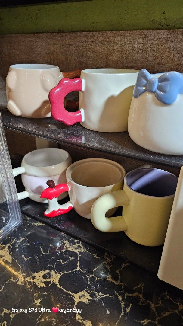 TAKE ALL Cute Ceramic Mugs with Unique Handles (Category: Coffee & Tea Tableware) located in Caloocan City. Submitted by auntieeyy (Listing ID 1452522128, Image 3). Description: TAKE ALL 12 PCS 1200 - Adorable ceramic mugs with unique, playful handle designs. - Features charming animal motifs and cute patterns. - Ideal for coffee, tea, or hot chocolate. - Adds a fun touch to your kitchen or makes a great gift. - Available for individual purchase 