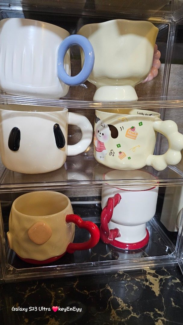 TAKE ALL Cute Ceramic Mugs with Unique Handles (Category: Coffee & Tea Tableware) located in Caloocan City. Submitted by auntieeyy (Listing ID 1452522128, Image 2). Description: TAKE ALL 12 PCS 1200 - Adorable ceramic mugs with unique, playful handle designs. - Features charming animal motifs and cute patterns. - Ideal for coffee, tea, or hot chocolate. - Adds a fun touch to your kitchen or makes a great gift. - Available for individual purchase 