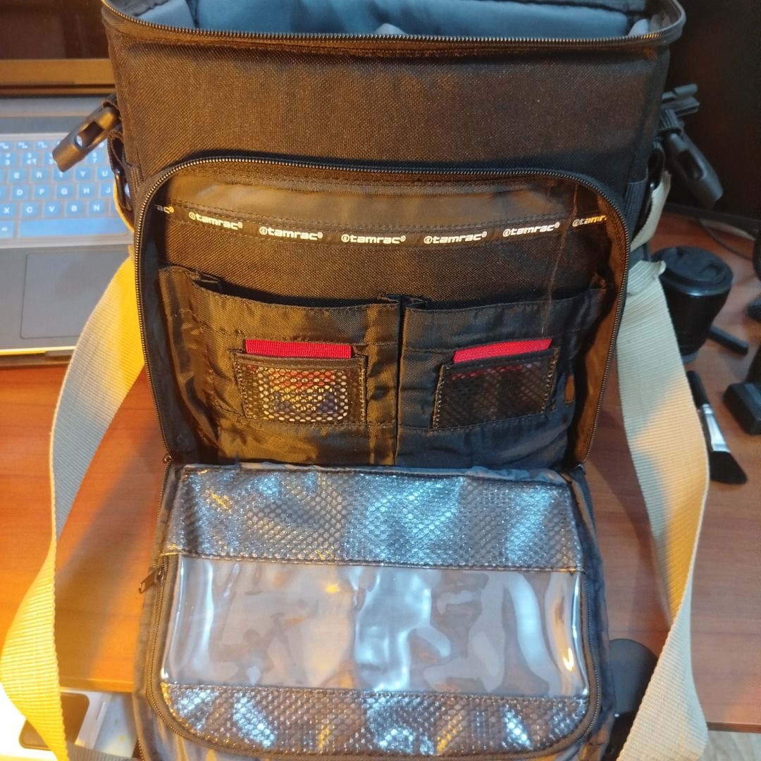 Tamrac Camera Bag (Category: Camera Bags & Carriers) located in Caloocan City. Submitted by cachero_kai (Listing ID 1452683337, Image 3). Description: - Black Tamrac camera bag - Multiple interior compartments for gear - Front organizer pockets - Clear pocket at the bottom - Adjustable strap included - Ideal for photographers on the go.