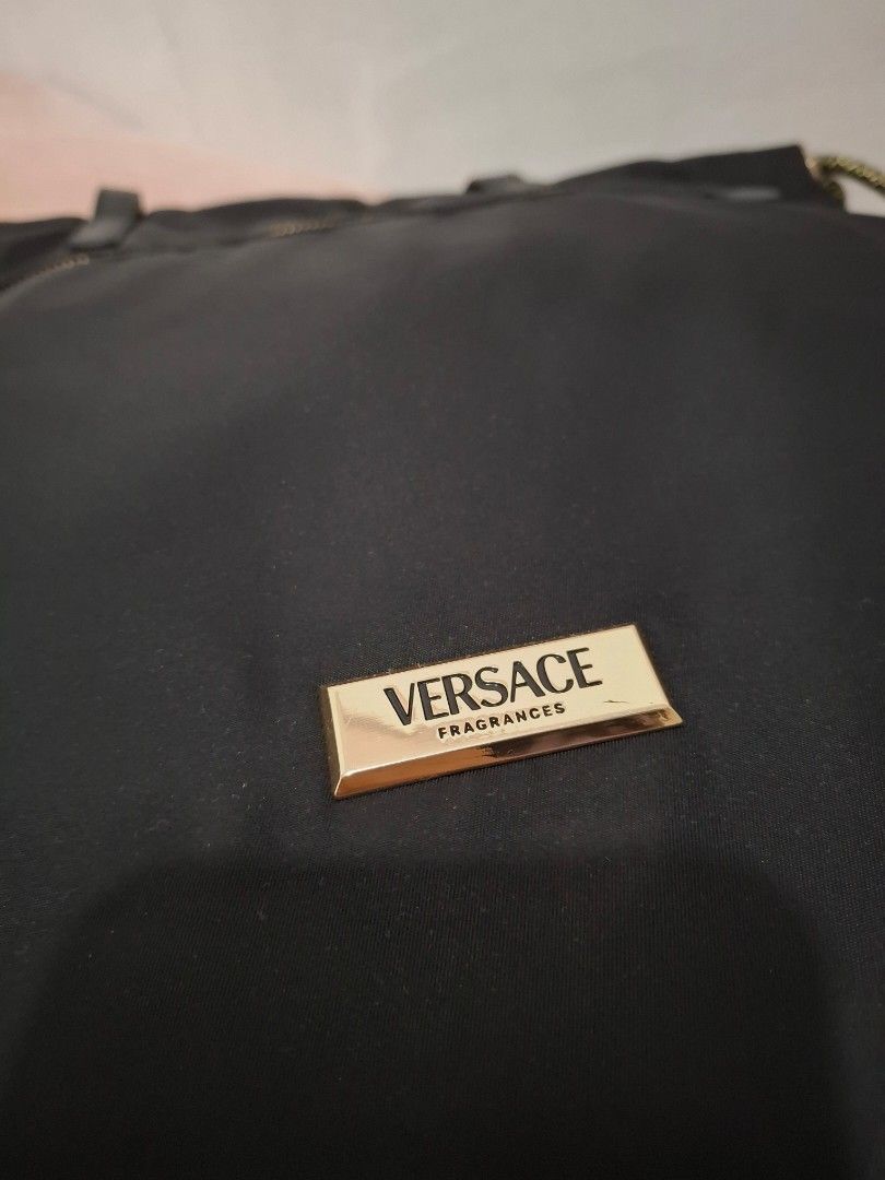 Versace Black Nylon Tote Bag (Category: Luxury Bags & Wallets) located in Las Pinas. Submitted by tn.gl (Listing ID 1452675013, Image 3). Description: - Black nylon tote bag from Versace Fragrances -Can Fit 14in. laptop - Elegant gold hardware details - Interior features Versace logo lining - Includes a convenient small pocket - Ideal for everyday use or travel used 3x only + free sf for sure buyer within metro manila.