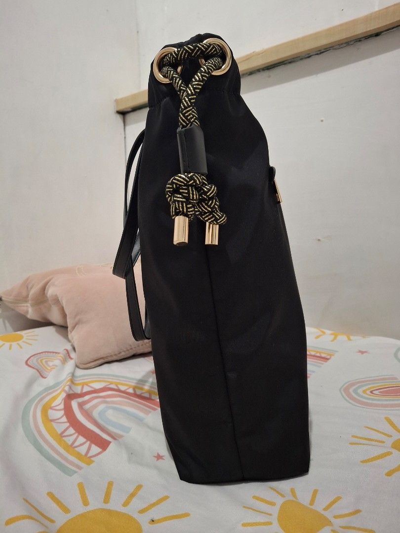 Versace Black Nylon Tote Bag (Category: Luxury Bags & Wallets) located in Las Pinas. Submitted by tn.gl (Listing ID 1452675013, Image 2). Description: - Black nylon tote bag from Versace Fragrances -Can Fit 14in. laptop - Elegant gold hardware details - Interior features Versace logo lining - Includes a convenient small pocket - Ideal for everyday use or travel used 3x only + free sf for sure buyer within metro manila.