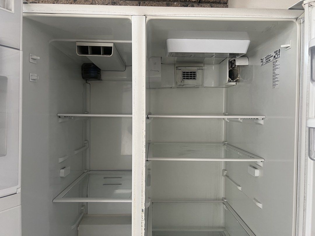 Whirlpool Side-by-Side Refrigerator with Water Dispenser (Category: Refrigerators and Freezers) located in Quezon City. Submitted by eisleya (Listing ID 1452661004, Image 3). Description: - White Whirlpool side-by-side refrigerator - Convenient water dispenser on the left door but need repair - All interior shelves and drawers are intact. No broken part. - Ample storage space inside - In working condition, but sometimes the refrigerator side gets