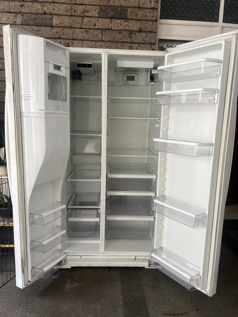 Whirlpool Side-by-Side Refrigerator with Water Dispenser (Category: Refrigerators and Freezers) located in Quezon City. Submitted by eisleya (Listing ID 1452661004, Image 2). Description: - White Whirlpool side-by-side refrigerator - Convenient water dispenser on the left door but need repair - All interior shelves and drawers are intact. No broken part. - Ample storage space inside - In working condition, but sometimes the refrigerator side gets