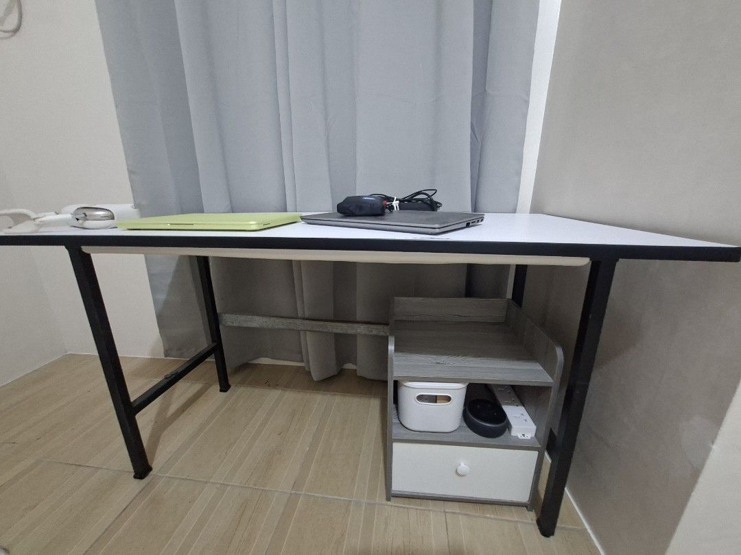 White and Black Study Desk Office Table (Category: Tables & Sets) located in Paranaque City. Submitted by potatoiceblended (Listing ID 1452608425, Image 1). Description: - Sleek white tabletop with sturdy black metal legs. - Ideal for students or creating a compact home workspace. - Note: Minor signs of wear on the metal support bar underneath. L 122 cm W 60 cm H 69 cm.