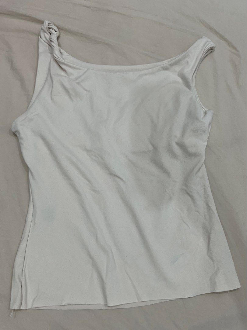 Beige Tank Top with Twisted Strap Detail (Category: Sleeveless) located in Quezon City. Submitted by goatedls (Listing ID 1452641860, Image 1). Description: - Simple white tank top - Unique twisted detail on one strap - Smooth, slightly shiny fabric - Can be dressed up or down - Raw cut hemline.